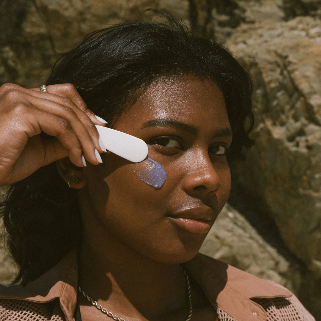 Smear of Super Acai Exfoliator close up on face at the beach 